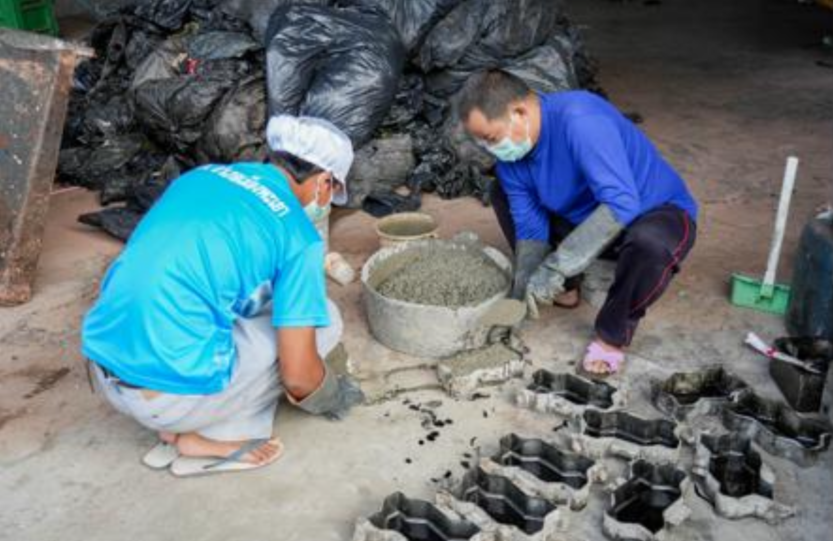 University staff producing worm blocks from residual plastic