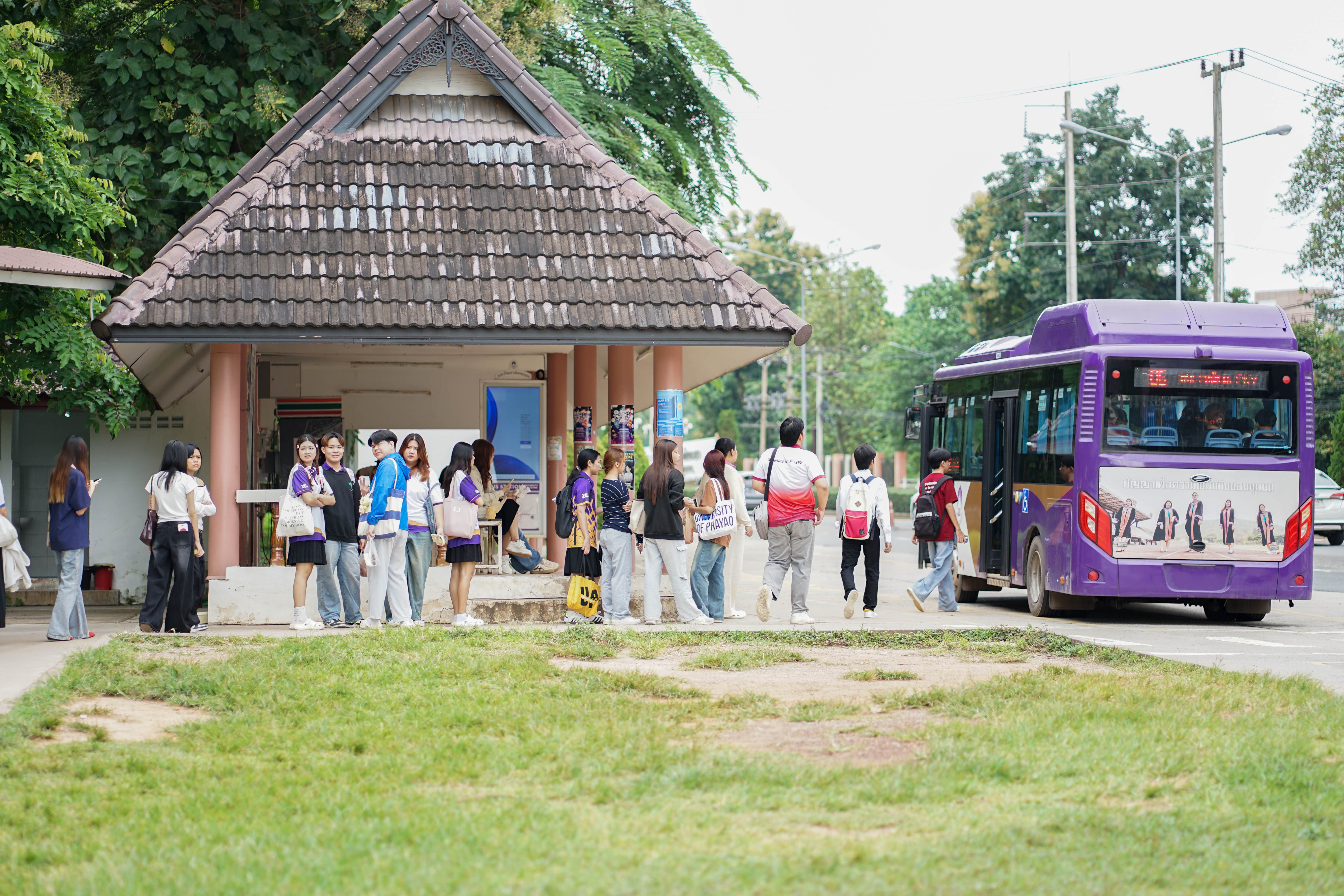 Electric shuttle bus at campus bus stop