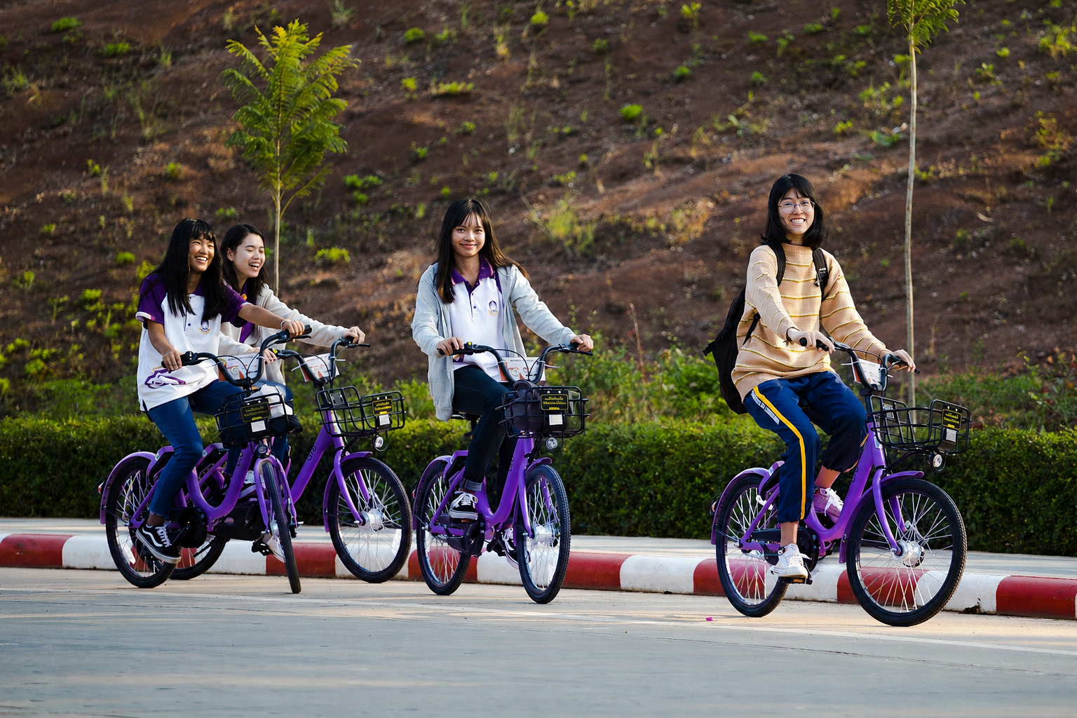 Students riding rental bicycles on campus