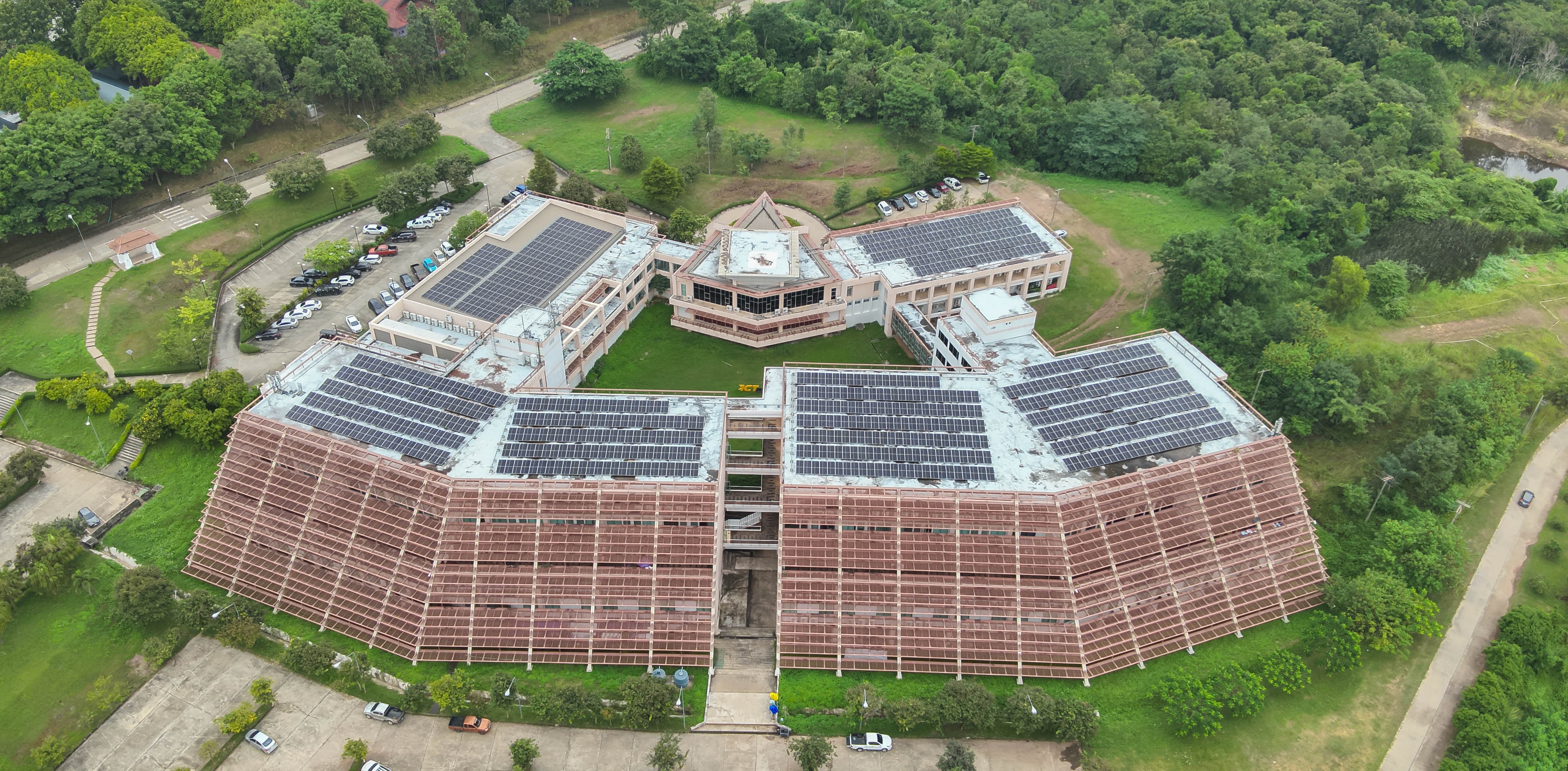Aerial view of dome building with solar panels