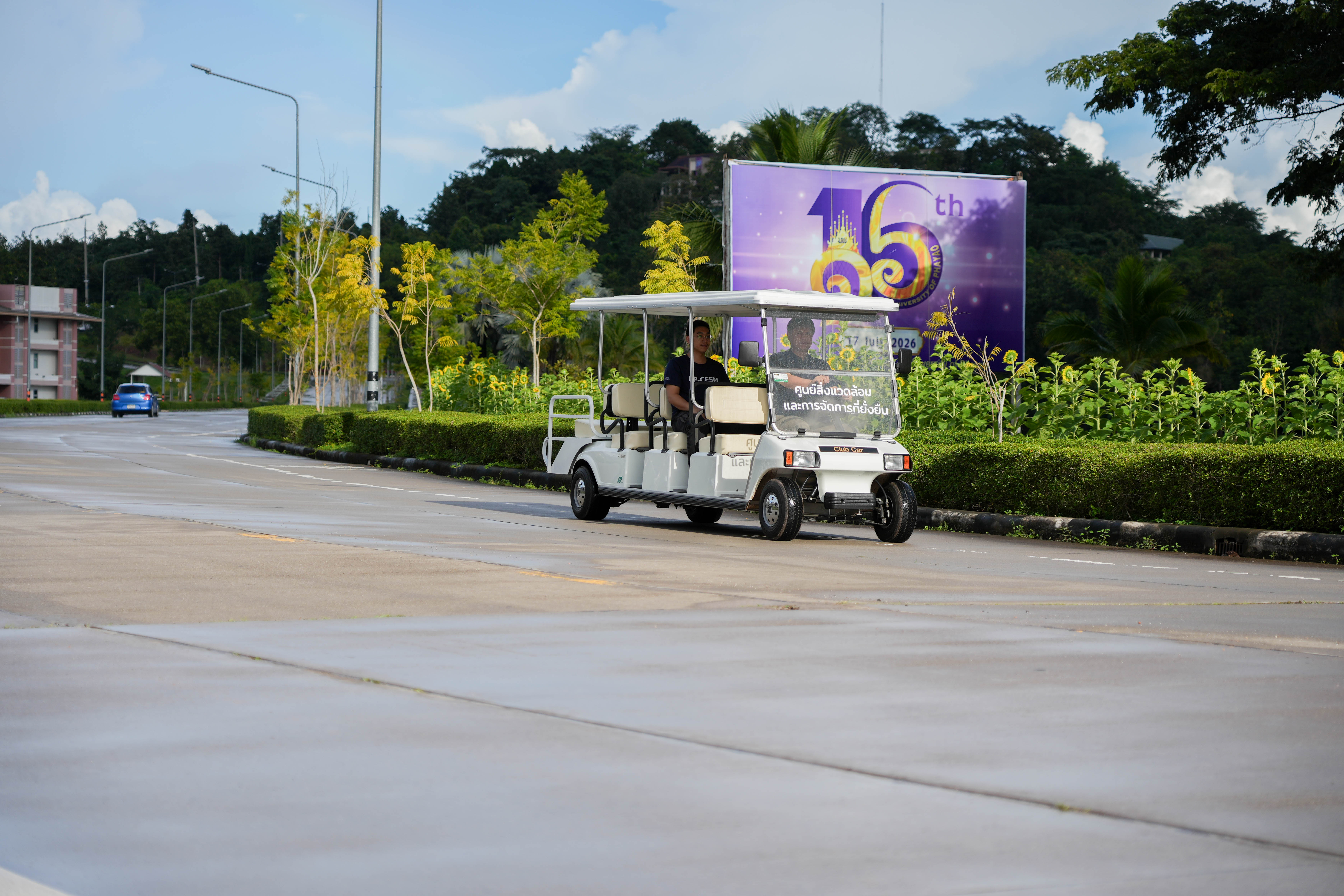 Electric golf cart on campus road