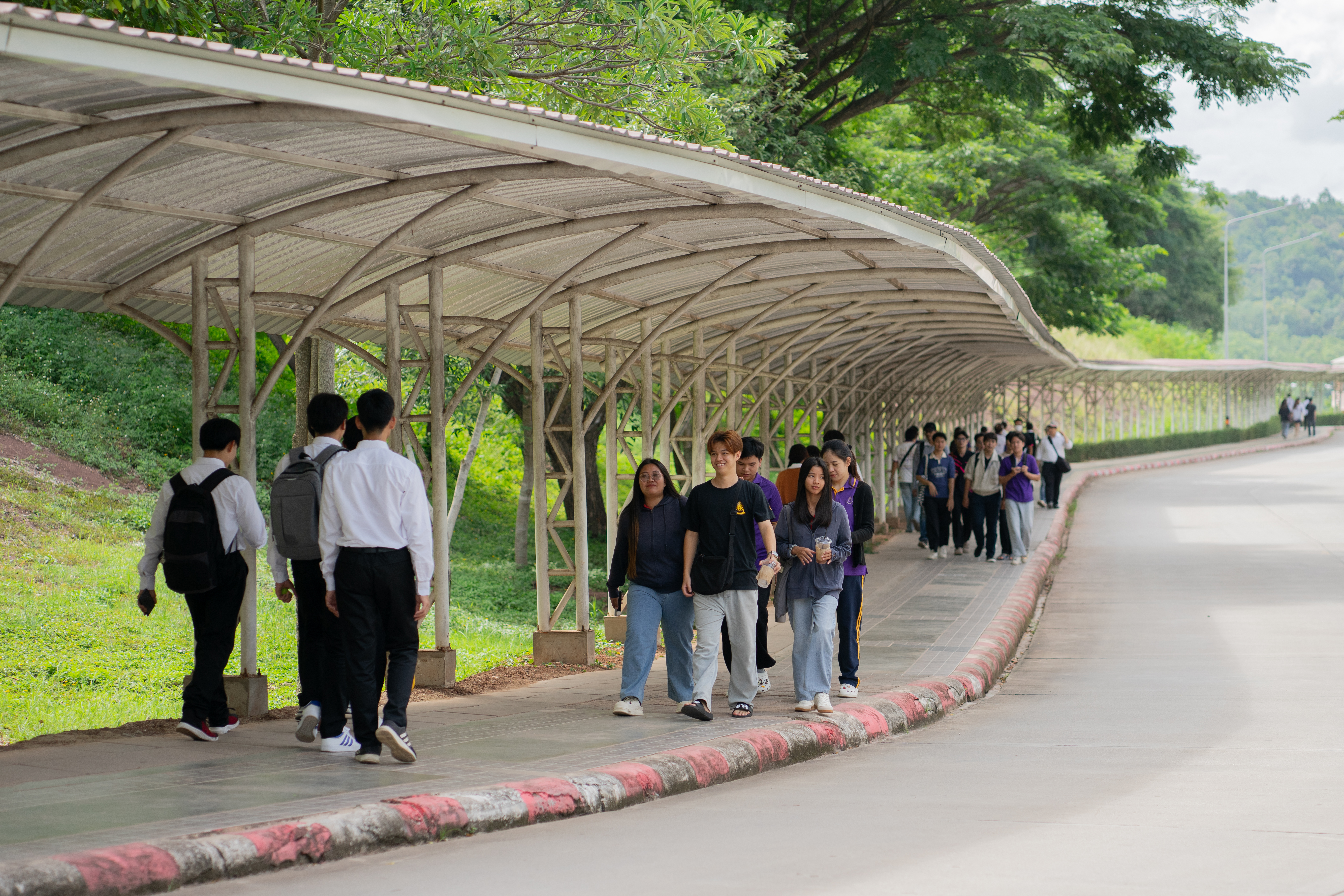 Covered pedestrian walkway with students, University of Phayao