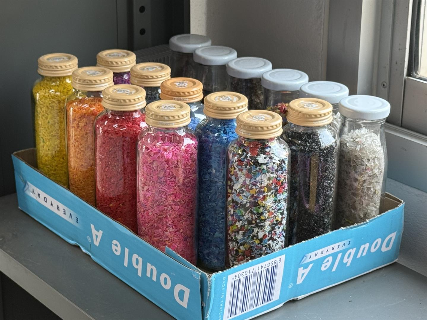 Sorted plastic pellets in storage jars