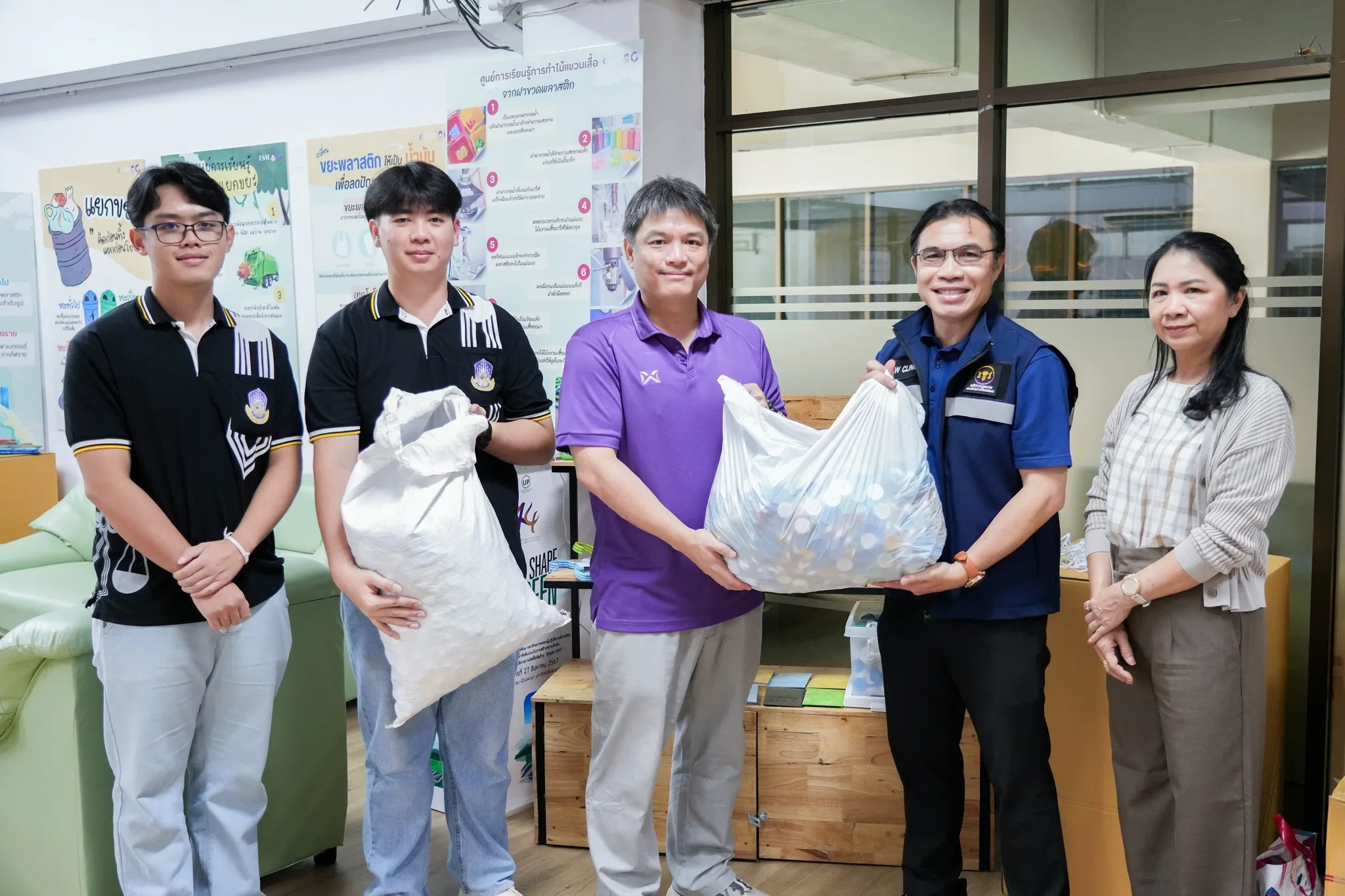 People holding donated plastic bottles for recycling